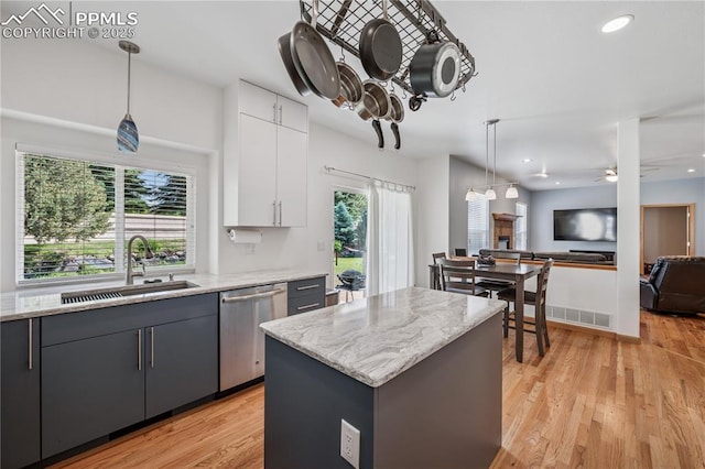 2664 Emerald Ridge Dr, Colorado Springs, CO 80920 - kitchen with stainless steel dishwasher, white cabinets, ceiling fan, pendant lighting, and recessed lighting