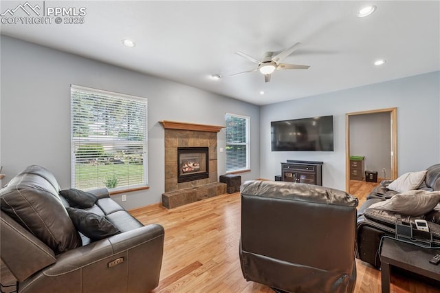 2664 Emerald Ridge Dr, Colorado Springs, CO 80920 - living area with a ceiling fan, healthy amount of natural light, light wood-style floors, a tile fireplace, and recessed lighting