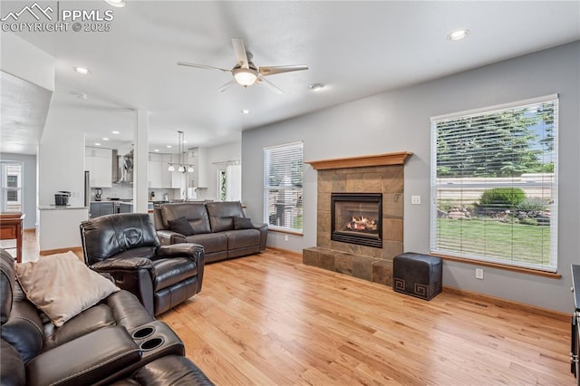 2664 Emerald Ridge Dr, Colorado Springs, CO 80920 - living area featuring a ceiling fan, light wood-style flooring, a tile fireplace, and recessed lighting