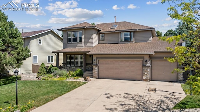 2664 Emerald Ridge Dr, Colorado Springs, CO 80920 - view of front facade with roof with shingles, driveway, a front lawn, a garage, and stone siding