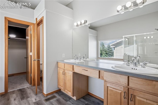 2664 Emerald Ridge Dr, Colorado Springs, CO 80920 - bathroom with wood finished floors, double vanity, and a shower stall