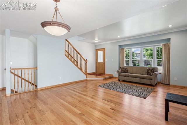 2664 Emerald Ridge Dr, Colorado Springs, CO 80920 - living area featuring wood finished floors, recessed lighting, crown molding, and stairway