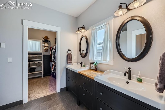 6975 H T Ranch Trl, Colorado Springs, CO 80908 - bathroom featuring double vanity and a walk in closet