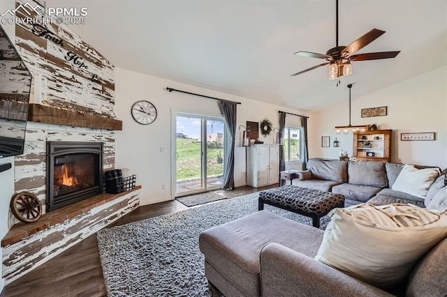 6975 H T Ranch Trl, Colorado Springs, CO 80908 - living room with dark wood-style floors, a ceiling fan, a large fireplace, and high vaulted ceiling
