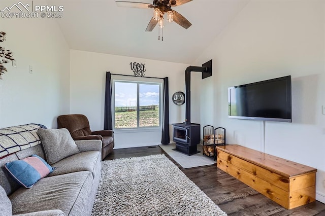 6975 H T Ranch Trl, Colorado Springs, CO 80908 - living room with dark wood-style floors, a wood stove, a ceiling fan, and high vaulted ceiling