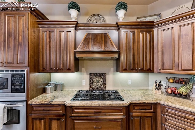 2585 Dunfries Ct, Colorado Springs, CO 80919 - kitchen with custom exhaust hood, stainless steel appliances, and light stone counters