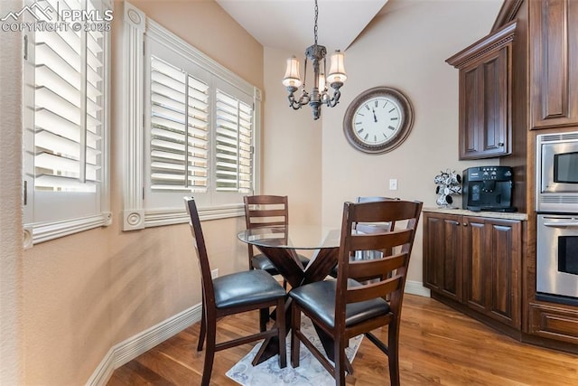 2585 Dunfries Ct, Colorado Springs, CO 80919 - dining space with a chandelier and light wood finished floors