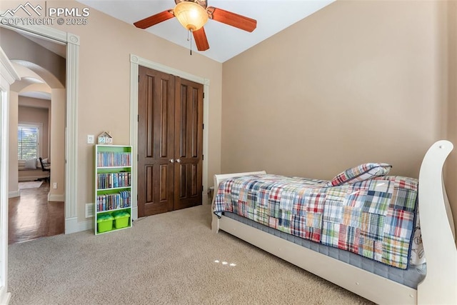 2585 Dunfries Ct, Colorado Springs, CO 80919 - bedroom featuring arched walkways, carpet flooring, a closet, and a ceiling fan