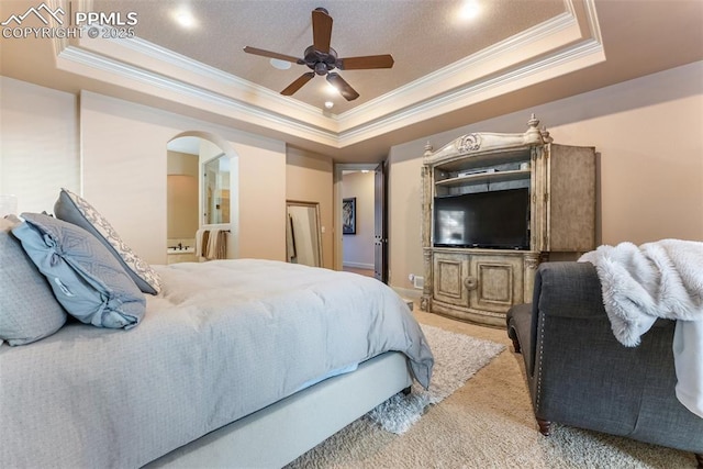 2585 Dunfries Ct, Colorado Springs, CO 80919 - bedroom with ornamental molding, a raised ceiling, arched walkways, carpet floors, and a ceiling fan