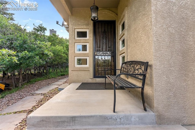 2585 Dunfries Ct, Colorado Springs, CO 80919 - doorway to property with stucco siding