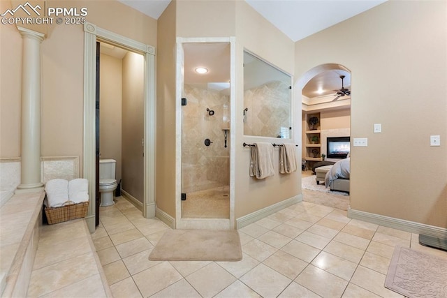 2585 Dunfries Ct, Colorado Springs, CO 80919 - full bath with a ceiling fan, decorative columns, a shower stall, and tile patterned floors