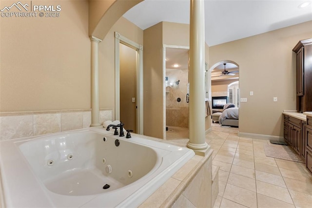 2585 Dunfries Ct, Colorado Springs, CO 80919 - bathroom with ornate columns, a ceiling fan, vanity, a tub with jets, and a stall shower