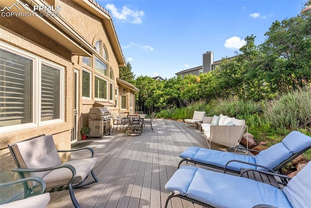2585 Dunfries Ct, Colorado Springs, CO 80919 - wooden terrace featuring outdoor dining area, an outdoor hangout area, and area for grilling