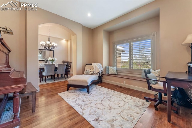 2585 Dunfries Ct, Colorado Springs, CO 80919 - office area with arched walkways, wood finished floors, a chandelier, and recessed lighting