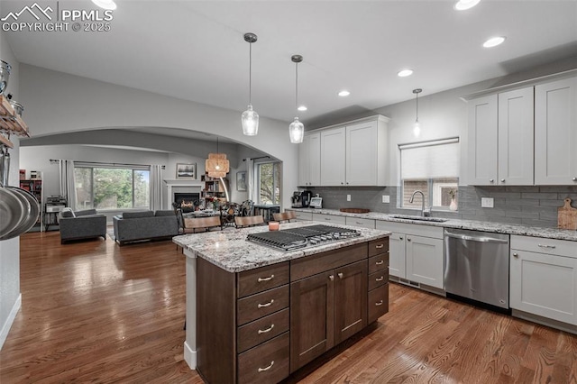 501 N Franklin St, Colorado Springs, CO 80903 - kitchen with stainless steel appliances, arched walkways, dark wood-style floors, open floor plan, and recessed lighting