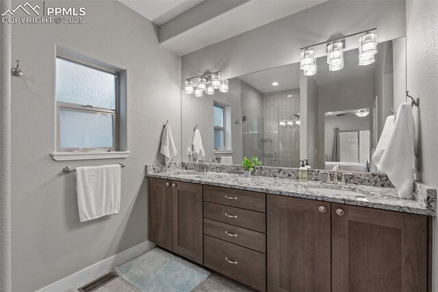 501 N Franklin St, Colorado Springs, CO 80903 - bathroom with a stall shower, double vanity, healthy amount of natural light, and tile patterned flooring