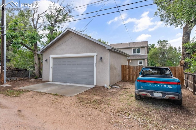 501 N Franklin St, Colorado Springs, CO 80903 - view of front of home featuring stucco siding, a garage, and dirt driveway