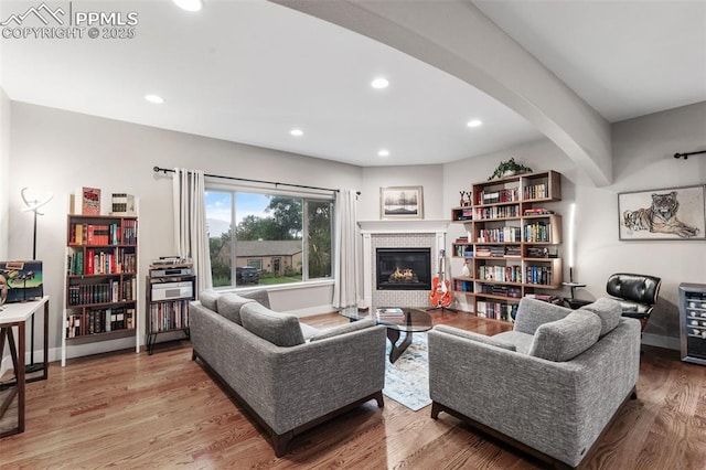 501 N Franklin St, Colorado Springs, CO 80903 - living room with a glass covered fireplace, arched walkways, wood finished floors, and recessed lighting