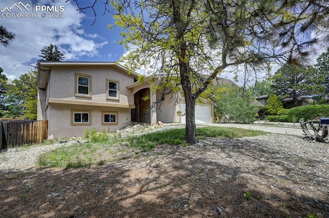 5926 Del Paz Dr, Colorado Springs, CO 80918 - view of front of home with stucco siding, concrete driveway, and an attached garage