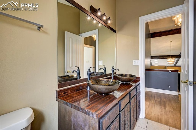 5926 Del Paz Dr, Colorado Springs, CO 80918 - bathroom with double vanity, tile patterned floors, and beamed ceiling