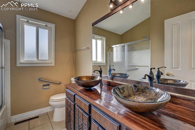 5926 Del Paz Dr, Colorado Springs, CO 80918 - full bathroom with vaulted ceiling, tile patterned flooring, double vanity, and a textured ceiling