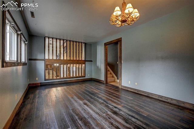 5926 Del Paz Dr, Colorado Springs, CO 80918 - spare room featuring a chandelier, wood finished floors, and stairway