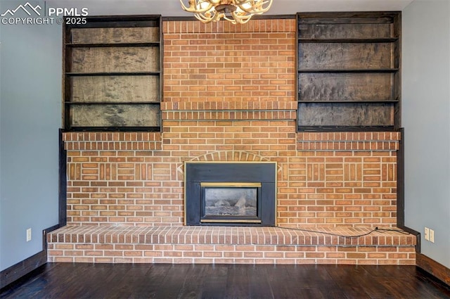 5926 Del Paz Dr, Colorado Springs, CO 80918 - detailed view of a chandelier, a brick fireplace, and wood finished floors