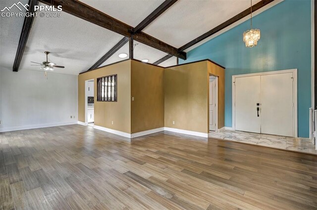 5926 Del Paz Dr, Colorado Springs, CO 80918 - unfurnished living room with a ceiling fan, a chandelier, and wood finished floors