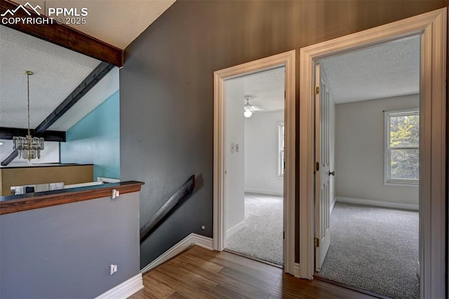 5926 Del Paz Dr, Colorado Springs, CO 80918 - stairs featuring a textured ceiling, wood finished floors, and a chandelier