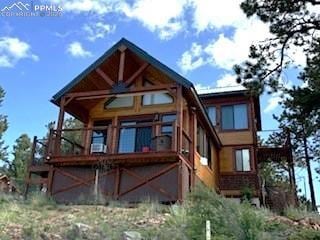 714 Woodrock Way, Divide, CO 80814 - rear view of house with a wooden deck