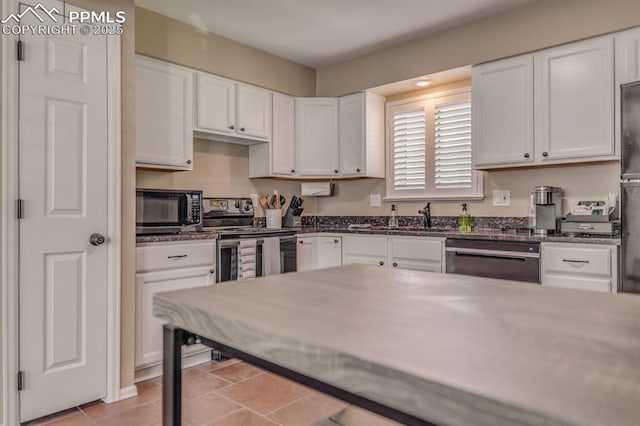 1607 N Chestnut St, Colorado Springs, CO 80907 - kitchen with appliances with stainless steel finishes and white cabinetry