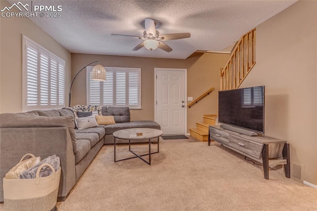1607 N Chestnut St, Colorado Springs, CO 80907 - carpeted living room with stairs, ceiling fan, and a textured ceiling