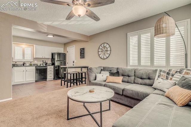 1607 N Chestnut St, Colorado Springs, CO 80907 - living area featuring a ceiling fan, a textured ceiling, light carpet, and light tile patterned flooring