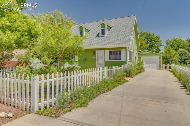 1607 N Chestnut St, Colorado Springs, CO 80907 - cape cod home featuring roof with shingles, an outdoor structure, a detached garage, and a fenced front yard