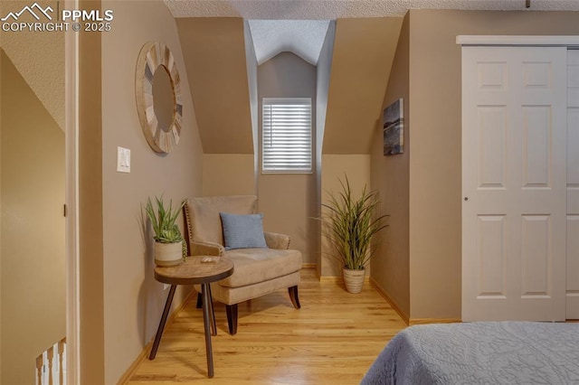 1607 N Chestnut St, Colorado Springs, CO 80907 - bedroom featuring light wood-style flooring, lofted ceiling, and a textured ceiling