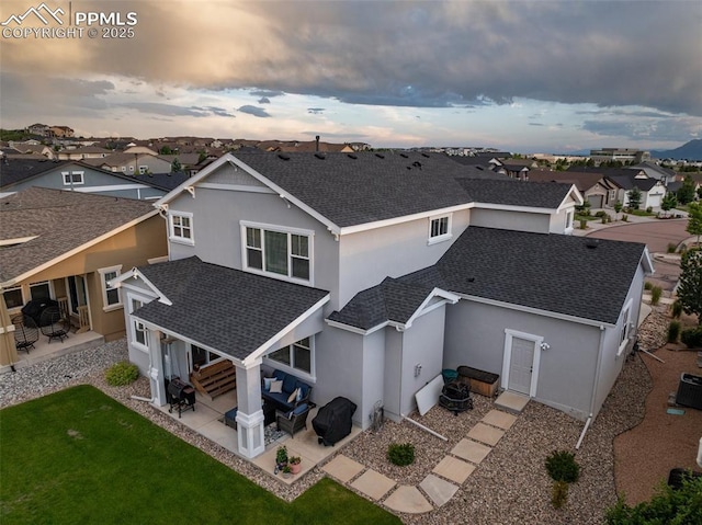 4296 New Santa Fe Trl, Colorado Springs, CO 80924 - back of house with roof with shingles, stucco siding, a patio, an outdoor living space, and a residential view