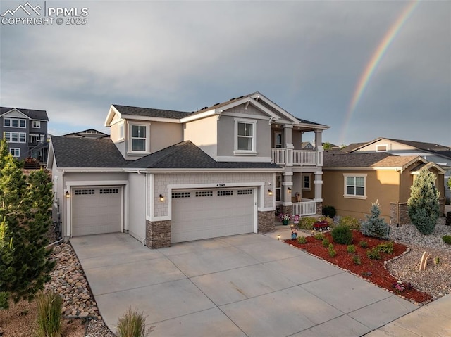 4296 New Santa Fe Trl, Colorado Springs, CO 80924 - view of front facade with concrete driveway, stone siding, a balcony, stucco siding, and an attached garage