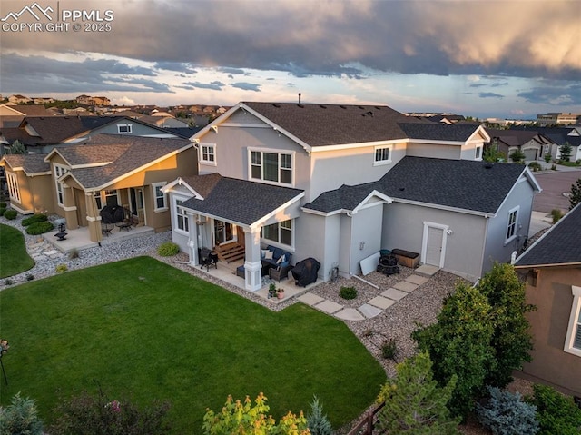 4296 New Santa Fe Trl, Colorado Springs, CO 80924 - back of house at dusk with a patio, a residential view, a shingled roof, and stucco siding