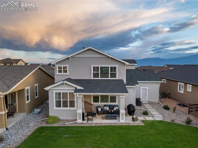 4296 New Santa Fe Trl, Colorado Springs, CO 80924 - rear view of house featuring an outdoor hangout area, a patio area, a yard, a mountain view, and stucco siding