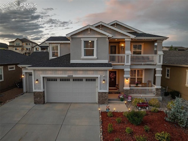 4296 New Santa Fe Trl, Colorado Springs, CO 80924 - craftsman inspired home featuring covered porch, concrete driveway, stone siding, and stucco siding