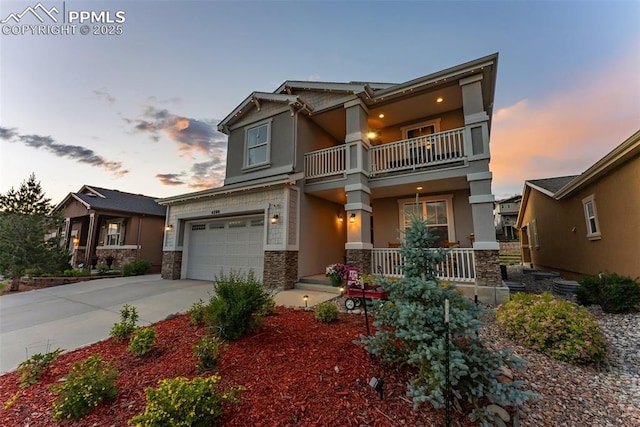 4296 New Santa Fe Trl, Colorado Springs, CO 80924 - craftsman house with a balcony, covered porch, stone siding, driveway, and a garage