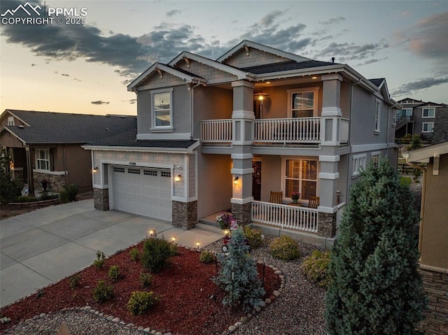 4296 New Santa Fe Trl, Colorado Springs, CO 80924 - craftsman house with covered porch, a balcony, concrete driveway, stucco siding, and stone siding
