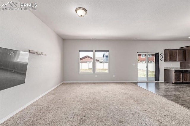 10726 Traders Pkwy, Fountain, CO 80817 - unfurnished living room with plenty of natural light and carpet flooring