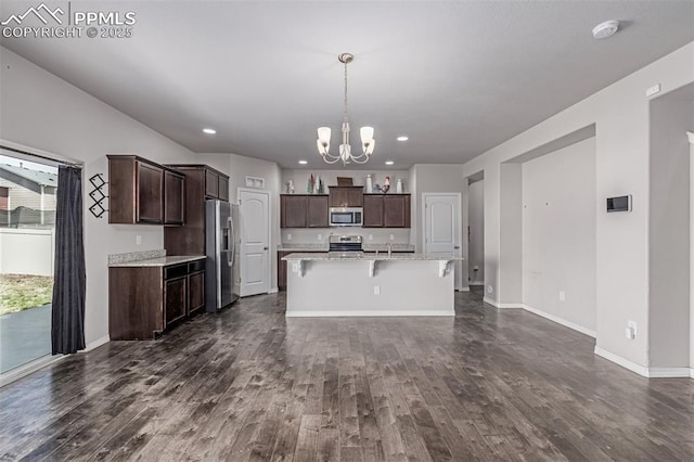 10726 Traders Pkwy, Fountain, CO 80817 - kitchen with appliances with stainless steel finishes, a chandelier, dark wood finished floors, dark brown cabinetry, and recessed lighting