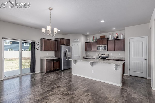 10726 Traders Pkwy, Fountain, CO 80817 - kitchen featuring appliances with stainless steel finishes, dark wood-type flooring, a chandelier, dark brown cabinetry, and recessed lighting