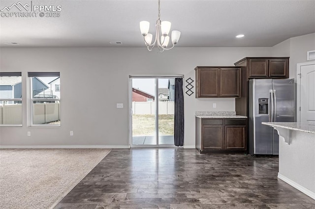 10726 Traders Pkwy, Fountain, CO 80817 - kitchen with stainless steel fridge with ice dispenser, dark brown cabinets, dark wood-style flooring, a chandelier, and pendant lighting