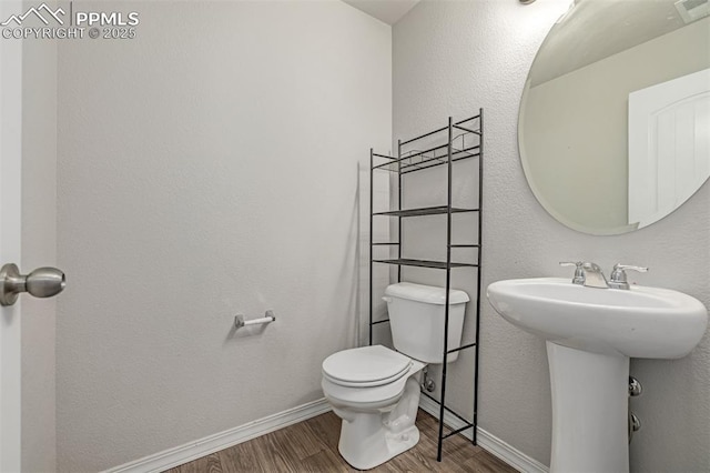 10726 Traders Pkwy, Fountain, CO 80817 - half bath featuring wood finished floors and toilet