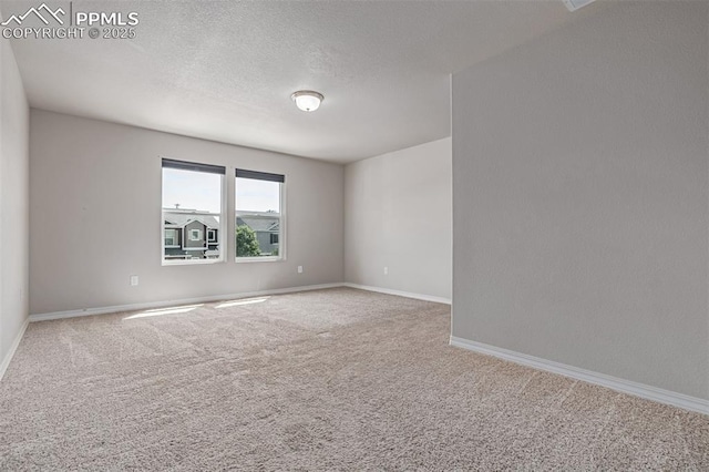 10726 Traders Pkwy, Fountain, CO 80817 - carpeted empty room featuring baseboards and a textured ceiling