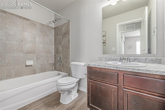 10726 Traders Pkwy, Fountain, CO 80817 - full bathroom with shower / tub combination, vanity, and wood finished floors