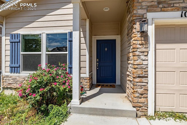 10726 Traders Pkwy, Fountain, CO 80817 - doorway to property featuring stone siding and an attached garage